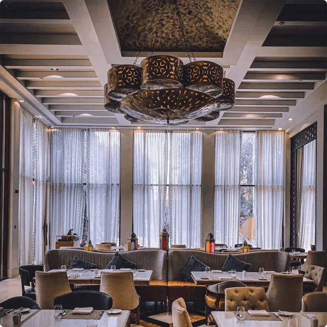 Luxurious restaurant interior with elegant dining tables and chandelier